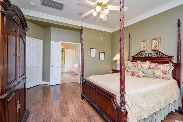 bedroom featuring a ceiling fan, visible vents, ensuite bath, ornamental molding, and dark wood-type flooring