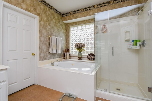 bathroom with tile patterned floors, a bath, and a shower stall