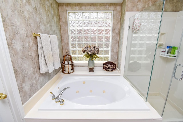 full bath with a shower stall, wallpapered walls, and a whirlpool tub