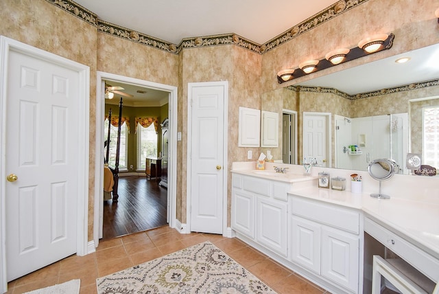 bathroom with tile patterned floors, ceiling fan, vanity, and baseboards