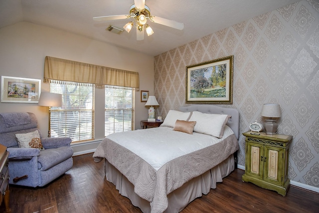 bedroom with visible vents, baseboards, wood finished floors, and wallpapered walls