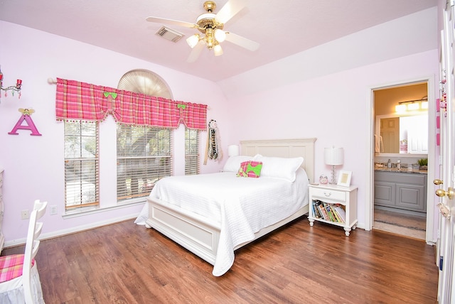 bedroom featuring visible vents, baseboards, lofted ceiling, and wood finished floors