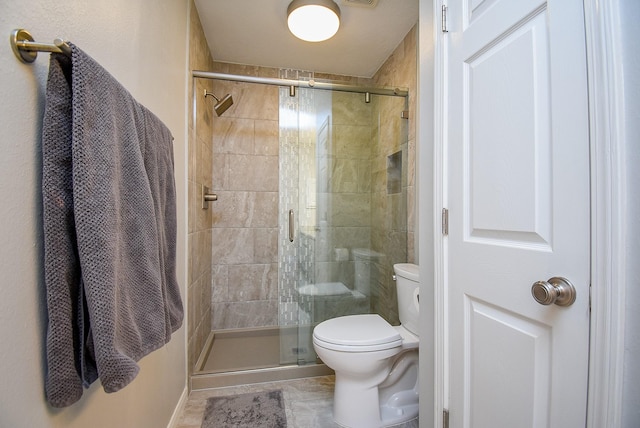 bathroom with toilet and a shower stall