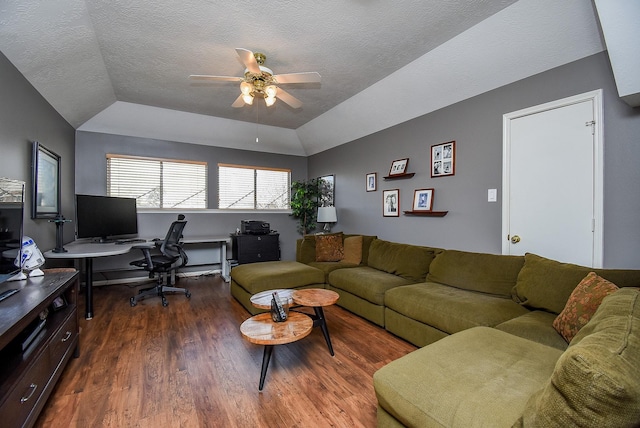 living area with wood finished floors, a ceiling fan, a raised ceiling, and a textured ceiling