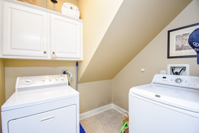 laundry room with light tile patterned floors, cabinet space, washer and clothes dryer, and baseboards