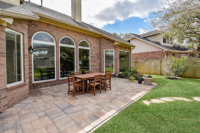 view of patio with outdoor dining space and fence