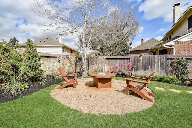 view of yard with a patio area, a fire pit, and fence