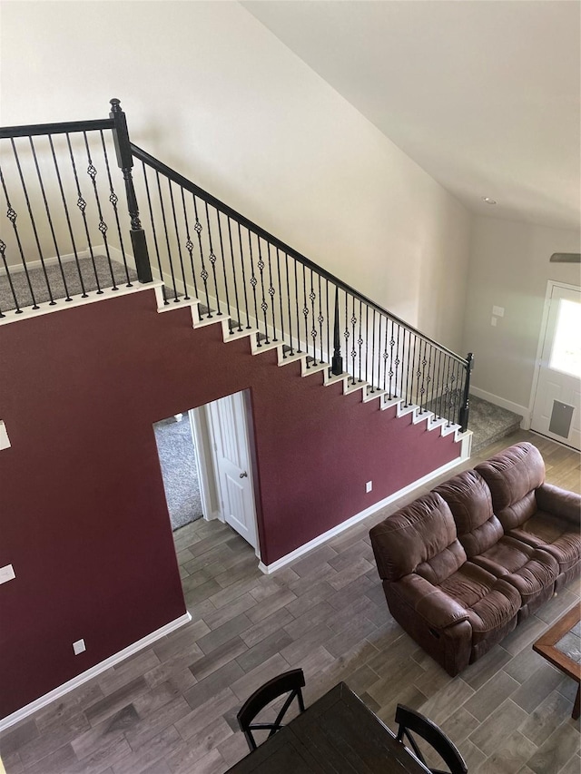 stairs with wood finished floors and baseboards