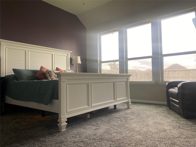 bedroom with lofted ceiling, carpet flooring, and baseboards