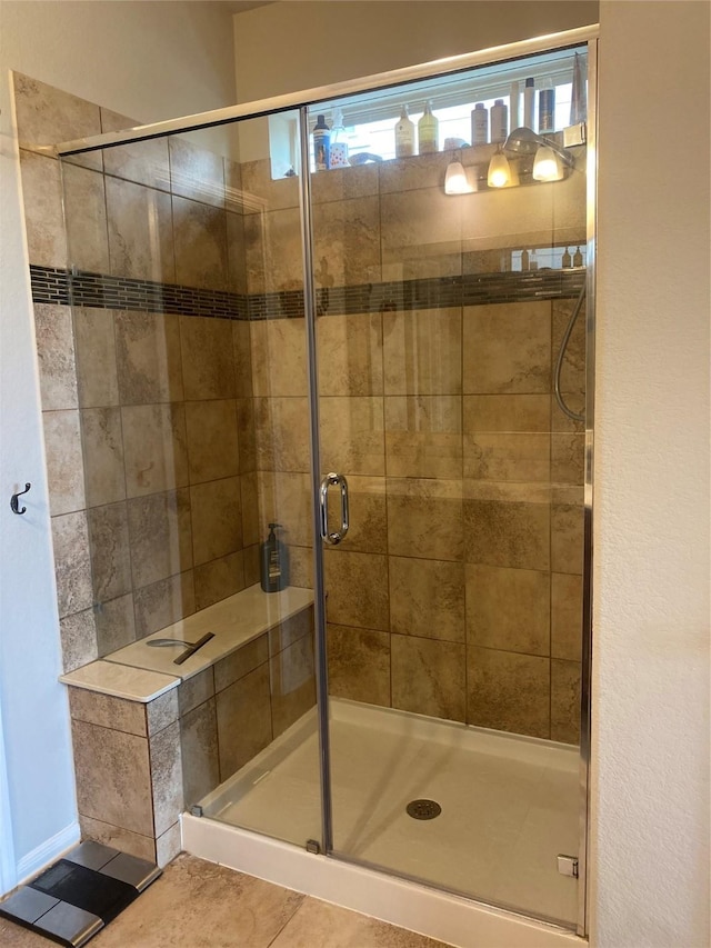 full bathroom featuring tile patterned flooring and a stall shower