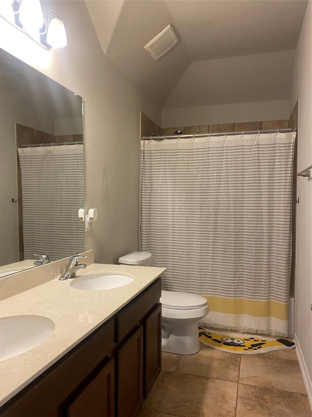 full bathroom with a sink, visible vents, lofted ceiling, and toilet