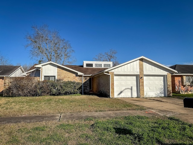 mid-century inspired home featuring an attached garage, brick siding, driveway, a front lawn, and board and batten siding