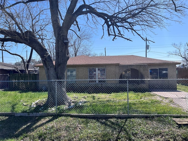 single story home with a fenced front yard, roof with shingles, a front lawn, and stucco siding