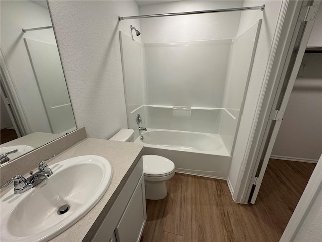 full bath featuring shower / washtub combination, vanity, toilet, and wood finished floors