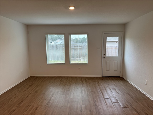 interior space with baseboards and wood finished floors