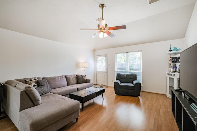 living room with light wood-style floors, vaulted ceiling, baseboards, and a ceiling fan