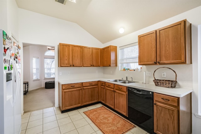 kitchen with lofted ceiling, light tile patterned flooring, a sink, dishwasher, and white fridge with ice dispenser