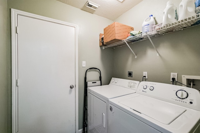 laundry area featuring washer and dryer, laundry area, and visible vents