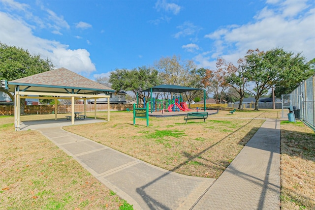 communal playground with a yard, fence, and a gazebo