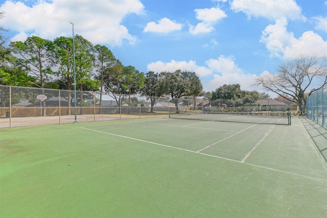 view of sport court featuring fence