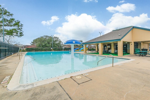 pool featuring fence and a patio