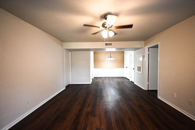 unfurnished bedroom with dark wood-style flooring, visible vents, and baseboards