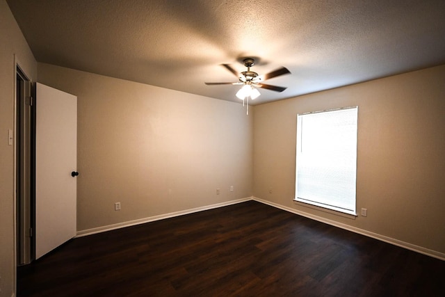 empty room featuring dark wood-style floors, a textured ceiling, a ceiling fan, and baseboards