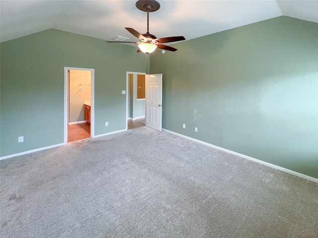 unfurnished bedroom with carpet floors, lofted ceiling, visible vents, and baseboards