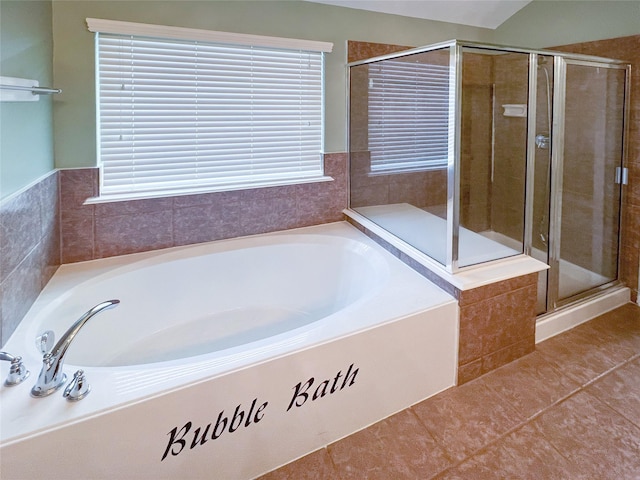 full bath featuring a stall shower and a garden tub