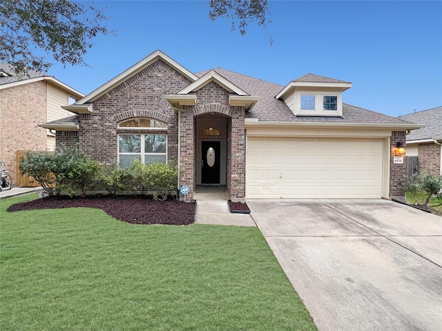 view of front of property featuring brick siding, roof with shingles, concrete driveway, an attached garage, and a front yard