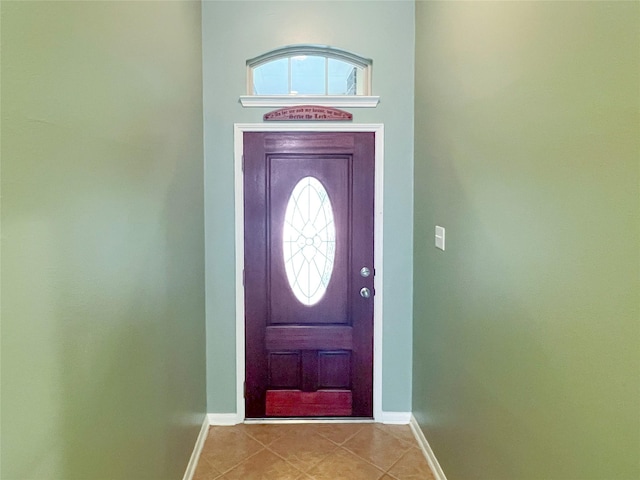 entryway featuring light tile patterned floors and baseboards