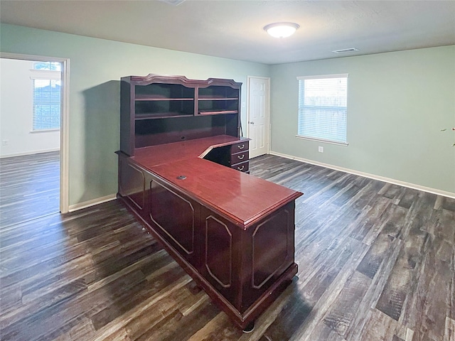 office with dark wood-style floors, visible vents, and baseboards