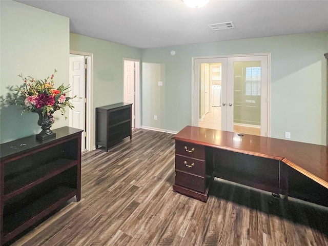 office space featuring french doors, dark wood-type flooring, visible vents, and baseboards