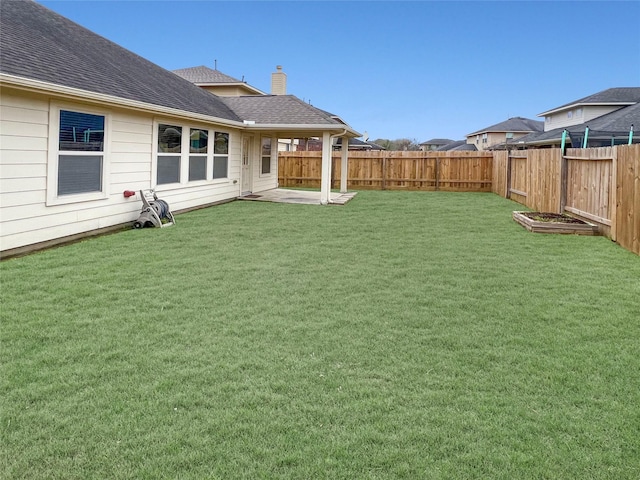 view of yard with a patio area and a fenced backyard