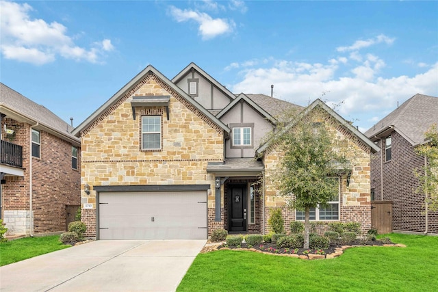 english style home featuring a shingled roof, concrete driveway, an attached garage, a front lawn, and stucco siding