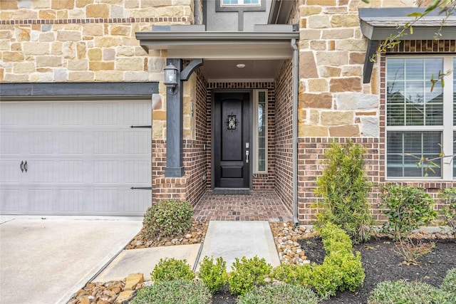 property entrance featuring a garage, stone siding, and brick siding