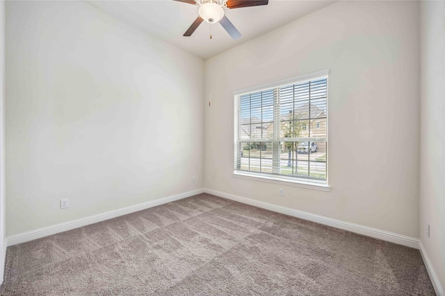 unfurnished room with a ceiling fan, baseboards, and carpet flooring