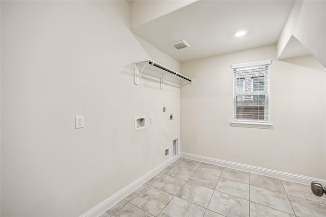 clothes washing area with washer hookup, gas dryer hookup, electric dryer hookup, laundry area, and baseboards