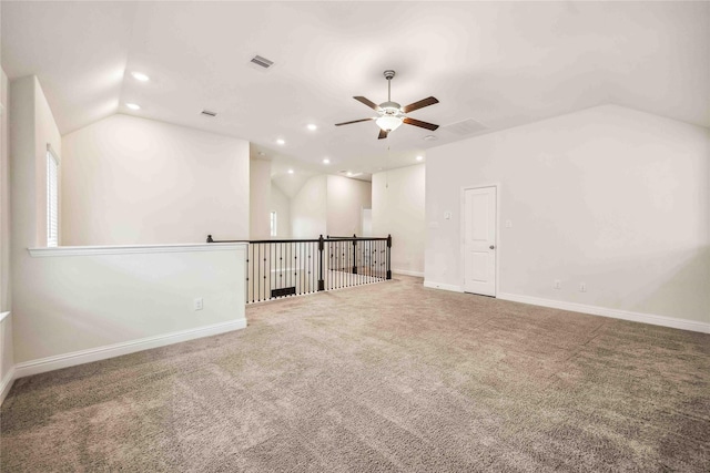 carpeted spare room with baseboards, vaulted ceiling, a ceiling fan, and recessed lighting