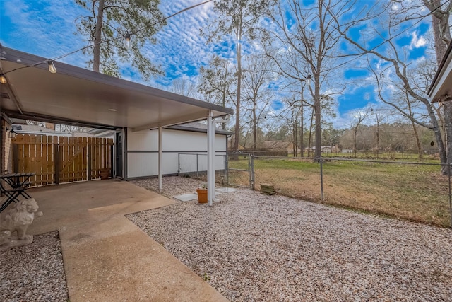 view of yard with a carport, a gate, and fence