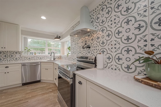 kitchen featuring crown molding, island exhaust hood, stainless steel appliances, tasteful backsplash, and a sink