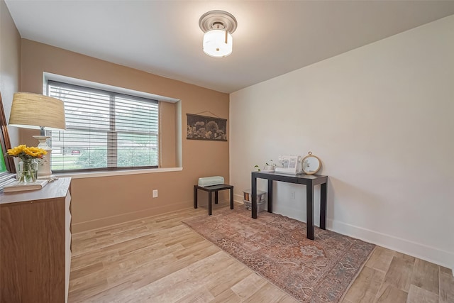 interior space with light wood-type flooring and baseboards