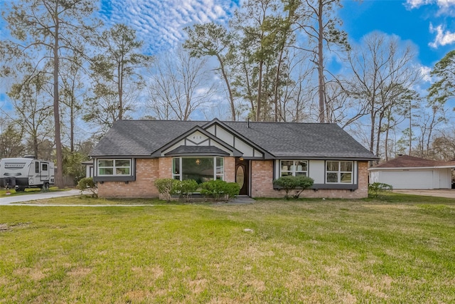 view of front facade with brick siding, a shingled roof, a garage, an outdoor structure, and a front lawn