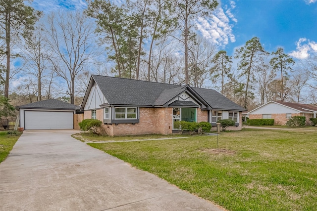 view of front of house with a garage, brick siding, an outdoor structure, roof with shingles, and a front yard