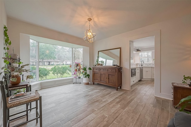 sitting room featuring light wood-style floors, baseboards, and a chandelier