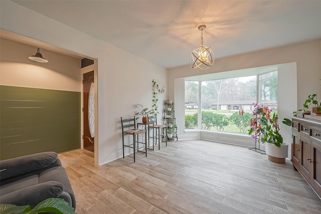 living area featuring a notable chandelier and light wood-style flooring