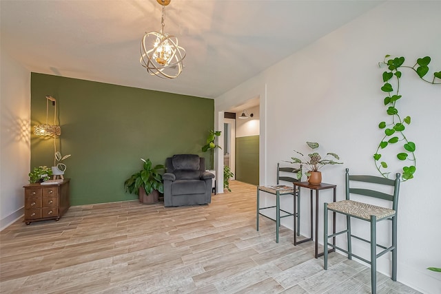 living area featuring wood finished floors and an inviting chandelier