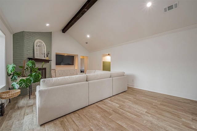 living area featuring high vaulted ceiling, visible vents, a brick fireplace, light wood finished floors, and beamed ceiling