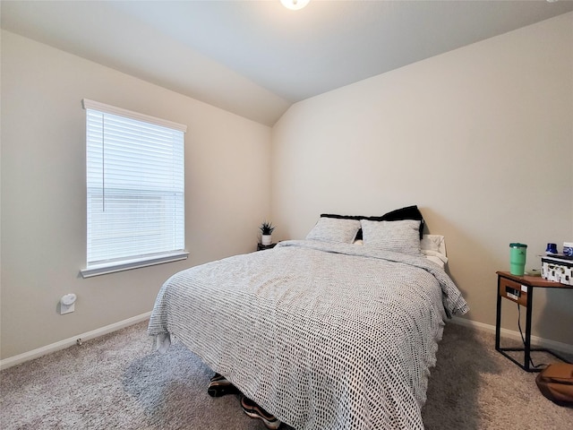 bedroom with lofted ceiling, carpet, and baseboards