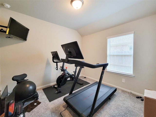 workout area with baseboards, vaulted ceiling, and carpet flooring